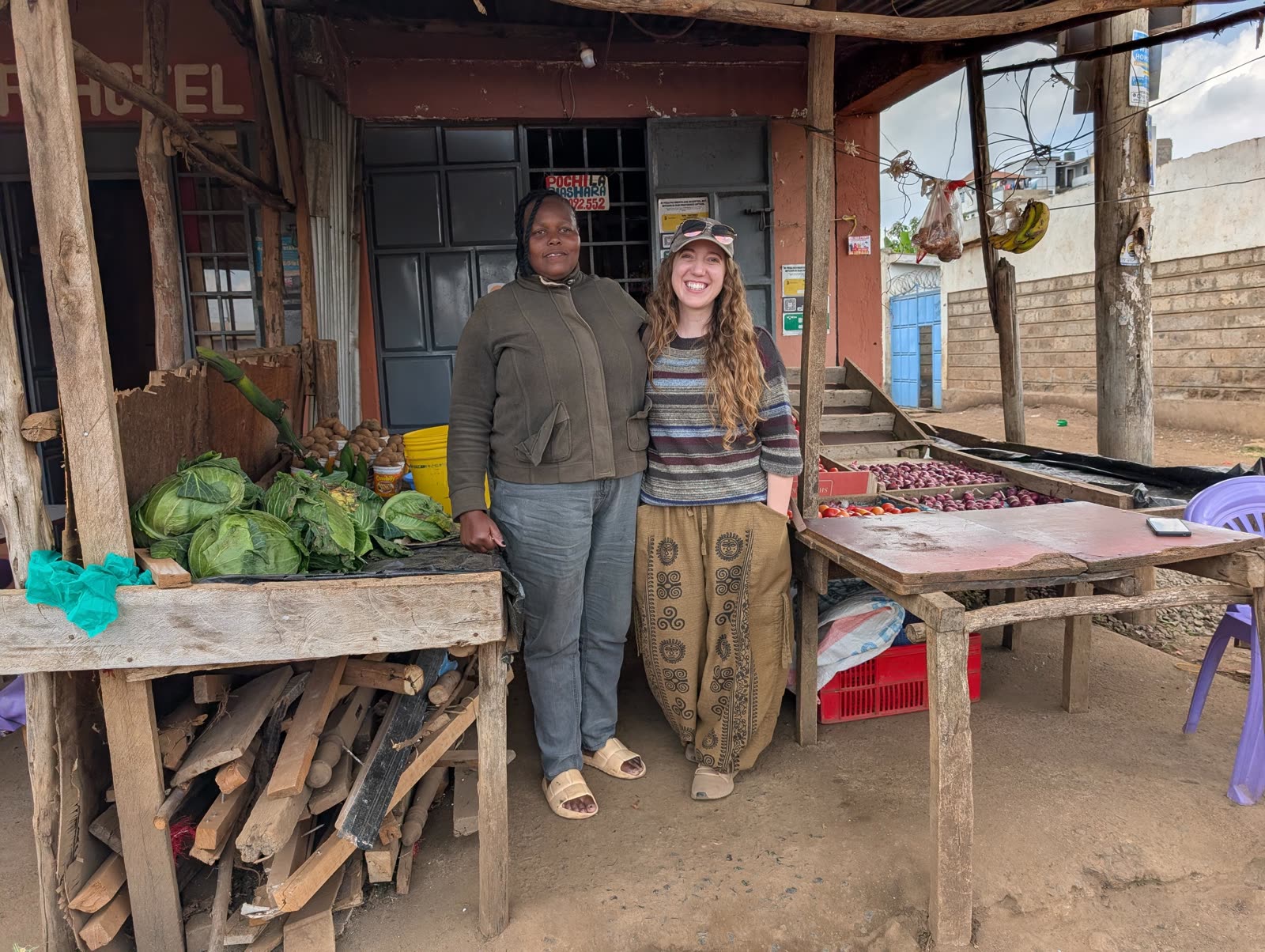 M.K. Fain with a Bitcoin-accepting vegetable merchant at her produce stand in Matangi, Kenya