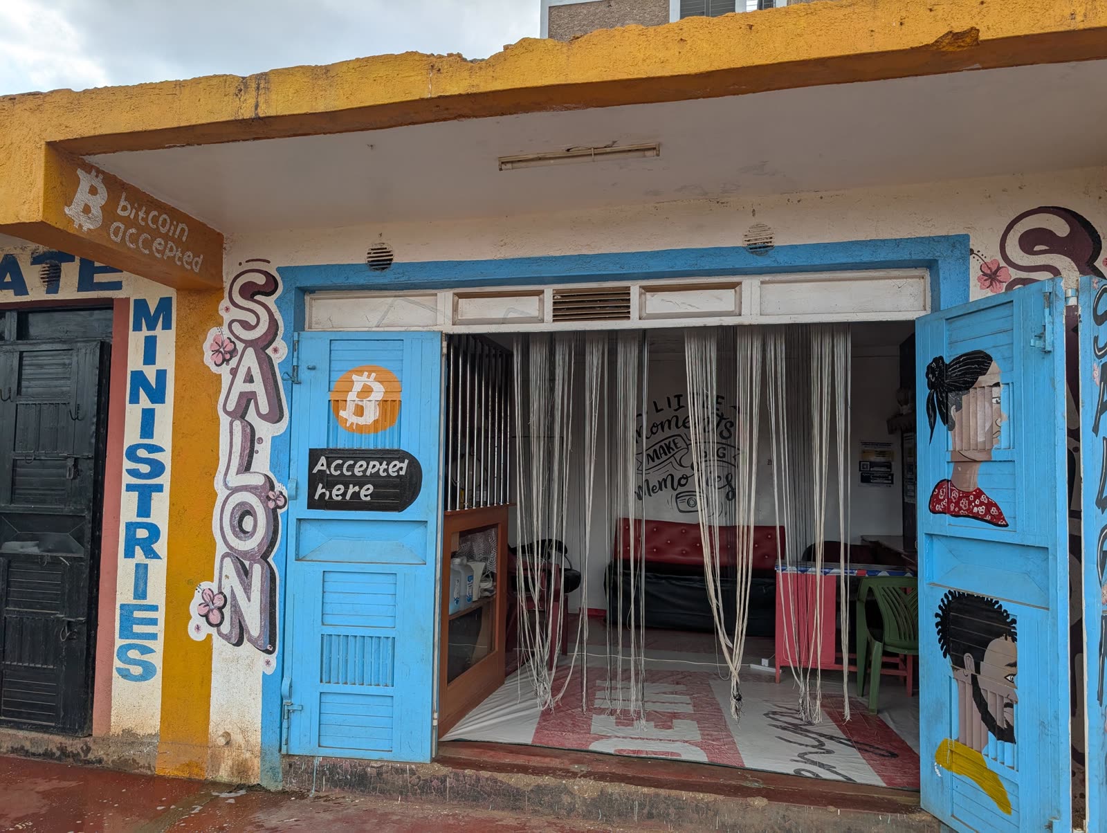 A salon in Matangi, Kenya with Bitcoin Accepted painted on its blue storefront doors