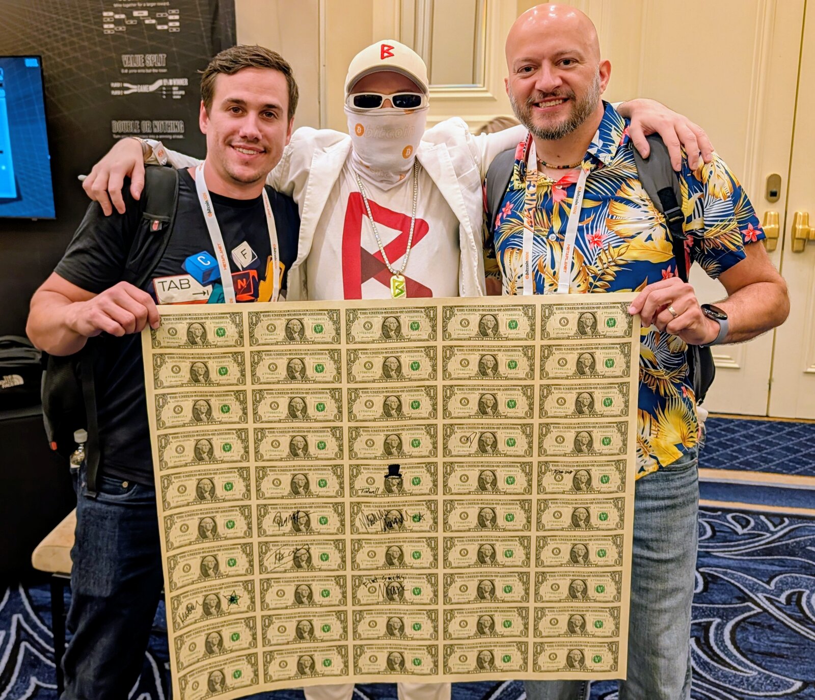 Derek Ross, Mike Tidwell, and Rockstar Dev backstage at the Vibe Coding on Bitcoin panel holding an uncut sheet of US dollar bills