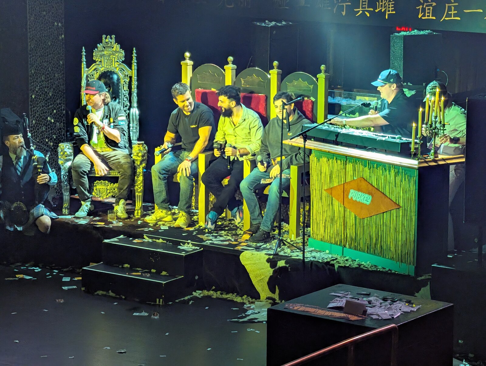 Live Rabbit Hole Recap recording at the PubKey Hotstyle Takeover, with panelists on a throne-style stage and confetti dollar bills covering the floor