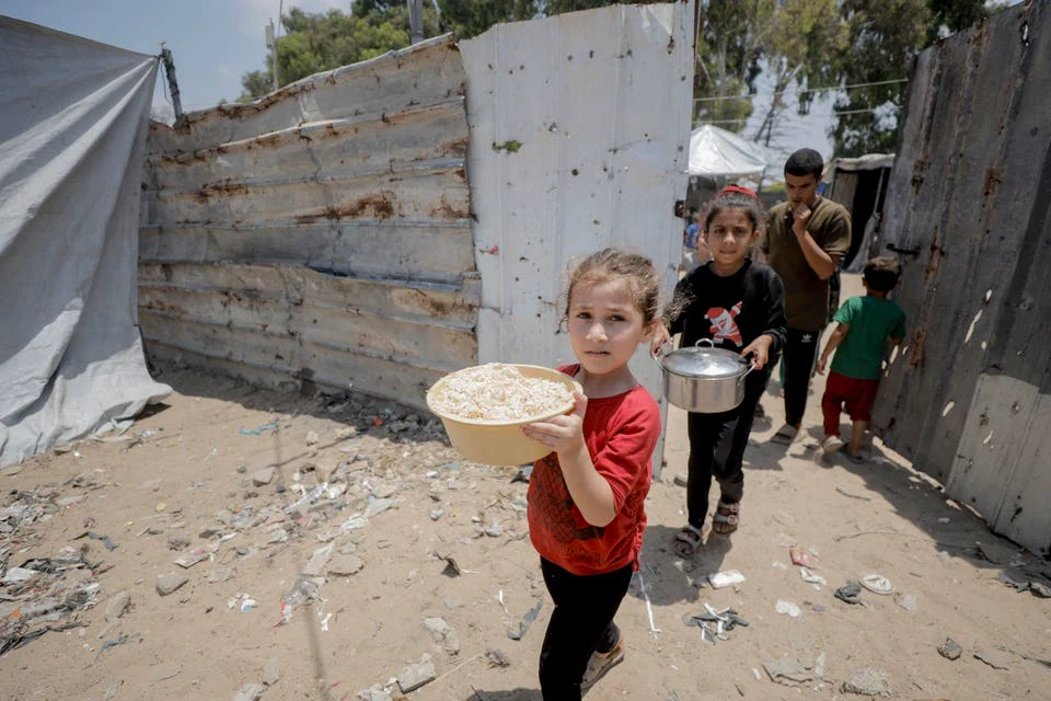 Food distribution in Gaza City — Forbes coverage of Bitcoin crisis fundraising